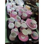 Mainly pink ground souvenir china in a variety of shapes (three trays)