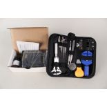 A watch repair kit and an electronic gold testing kit
