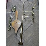 A set of three brass fire irons, andirons,