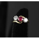 An 18ct gold ruby and diamond three stone ring,