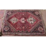 A Persian floral red ground rug,