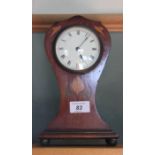 An Edwardian Art Nouveau inlaid mahogany waisted mantel clock