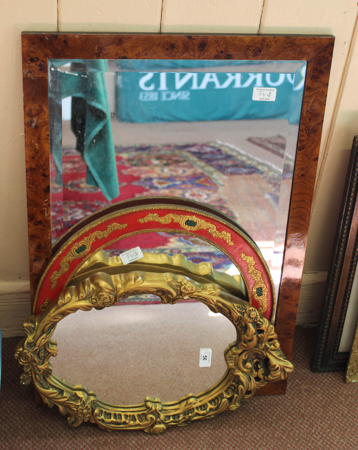 A rectangular burr walnut framed wall mirror plus two others