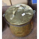 A large 19th Century brass cauldron with lid and iron swing handle,