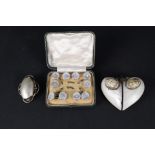 A mother of pearl crucifix and button set yellow metal mounted brooch, a large shell pendant,