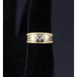 A very pretty antique band ring with beaded border set with three diamonds in embossed floral