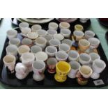 A quantity of various egg cups plus a collectors book