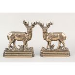 A pair of heavy 19th Century brass or gun metal stag door stops on shaped bases,