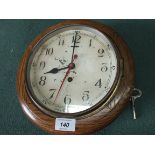 An oak cased circular dial clock