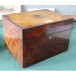 A 19th Century walnut toilet box containing silver plate top bottles and implements,