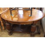 A 1930's oak extending dining table with two leaves and heavily bulbous legs