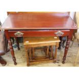 A reproduction mahogany single drawer table and an oak nest of three tables