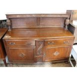 A 1930's oak sideboard with shelved upstand