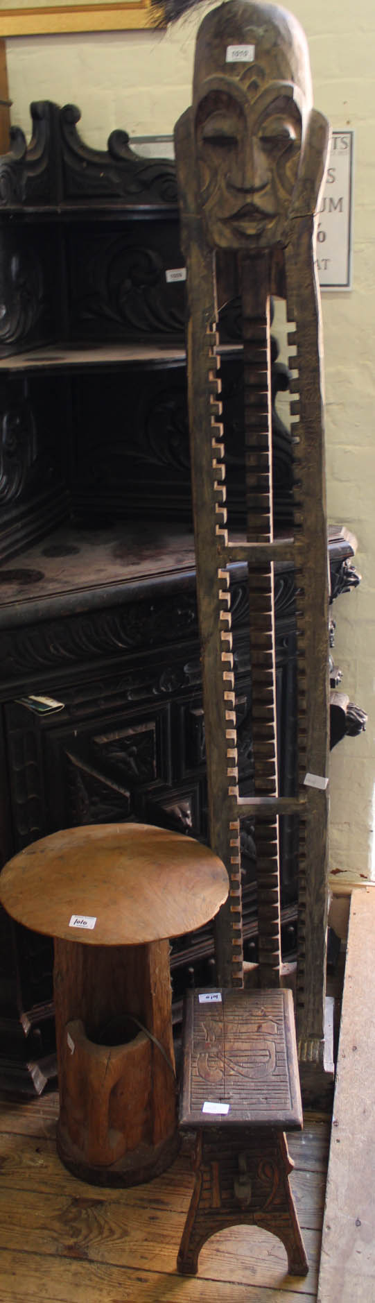 Three African style carved hardwood items including tall CD rack and stool