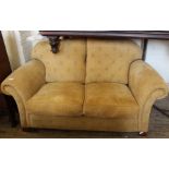 A gold upholstered two seater sofa