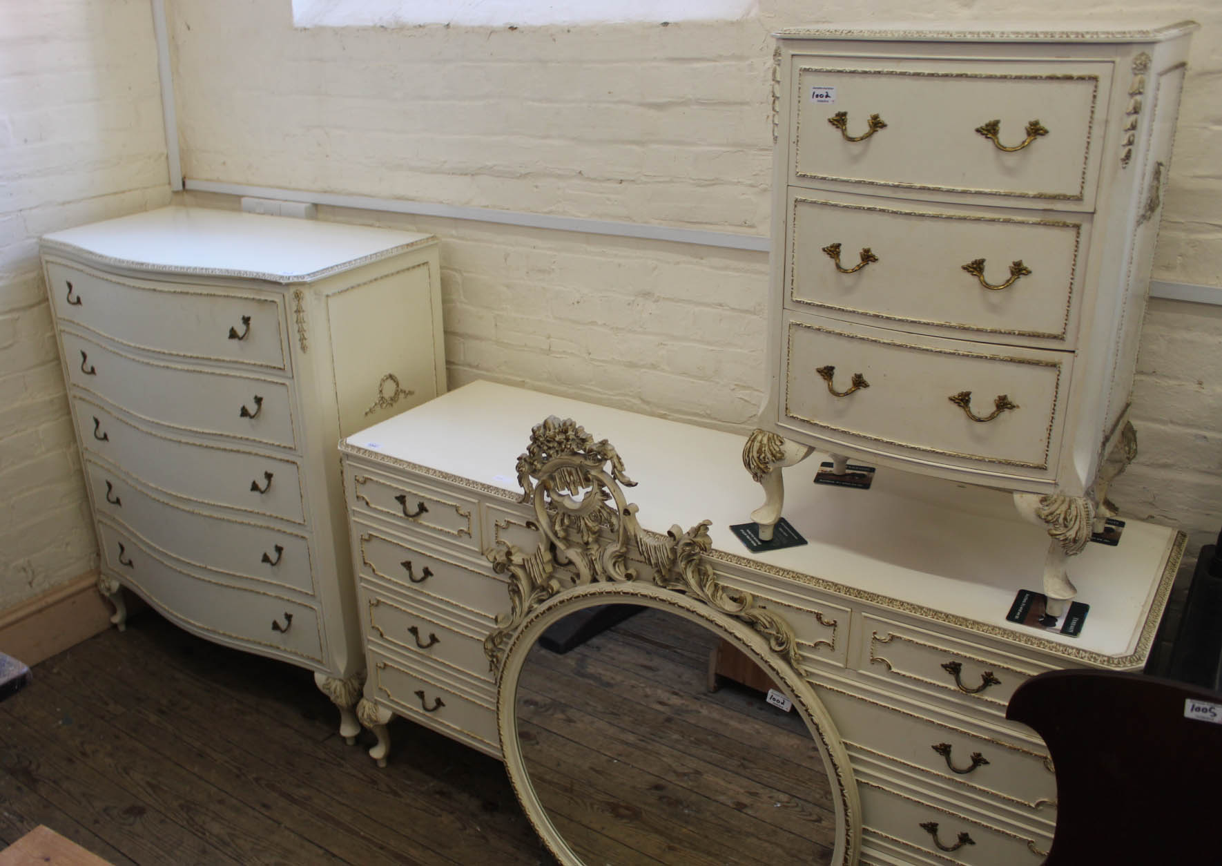 A cream and gilt French style chest of drawers,