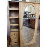 The middle section of a pine triple wardrobe with oval mirror,