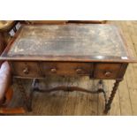 A 1920's oak barley twist writing desk with leather inset top and three drawers