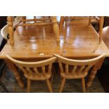 A modern pine dining table with three beech dining chairs