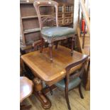 A 1920's oak extending dining table with three Victorian mahogany dining chairs