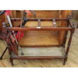 An Edwardian mahogany stick stand with drip tray