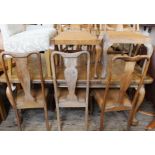 A walnut dining table with eight chairs including two carvers (one as found)