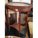 An Edwardian style oval mahogany table with glass tray to top and under tier