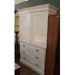 A white painted late Victorian pine linen press with three drawers