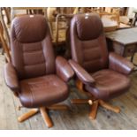 A pair of brown Stressless style leatherette reclining arm chairs