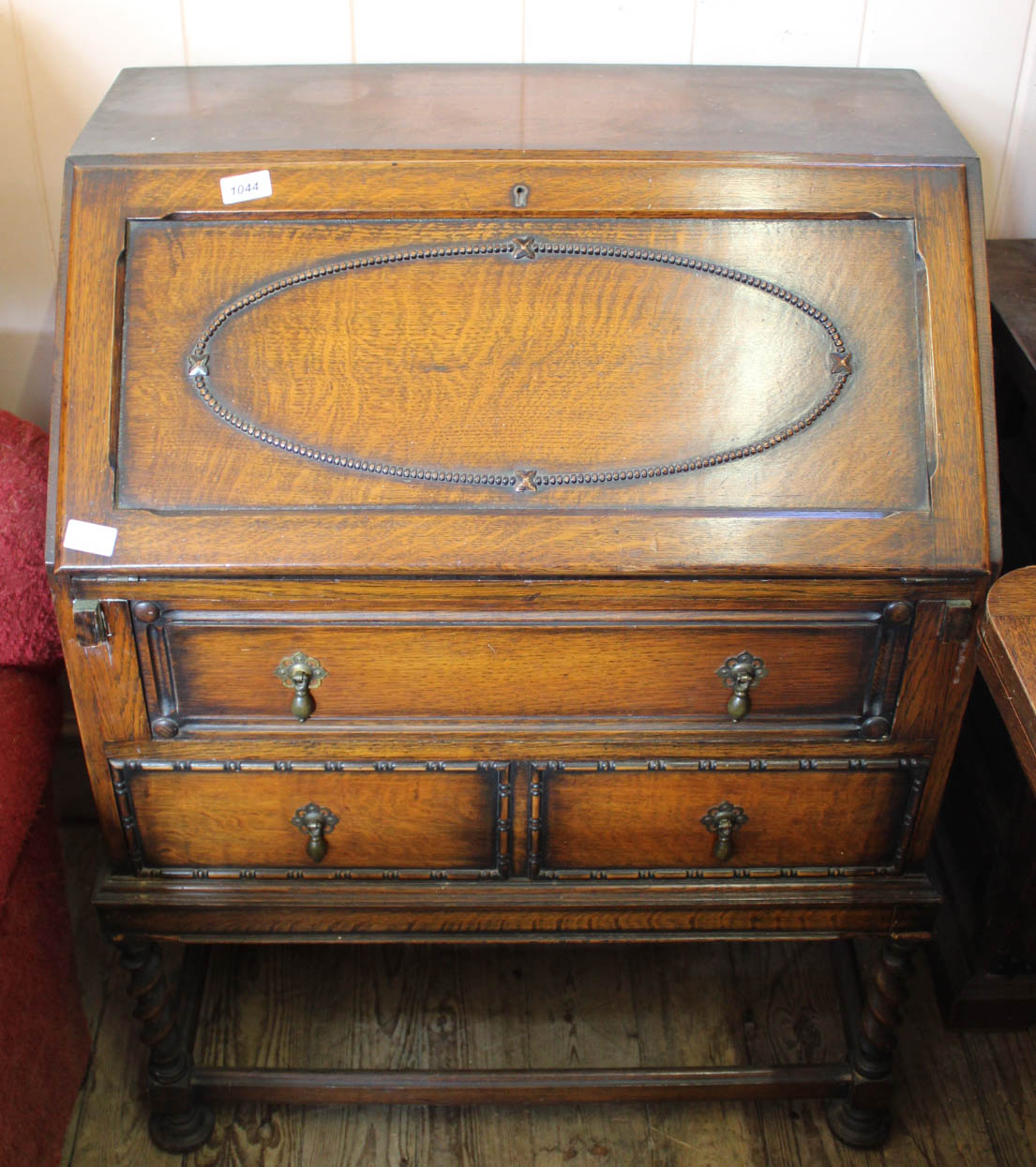 A 1920's oak bureau on stretcher base