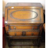 A 1920's oak bureau on stretcher base