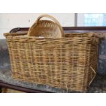 A large wicker log basket and other baskets