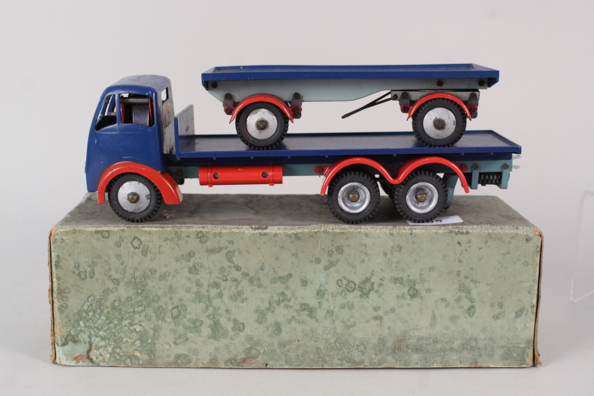 A boxed Shackleton blue and red Foden truck and open trailer (largely complete but missing three