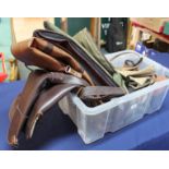 A box of various gun slips with a selection of rods and brushes etc and a camo net