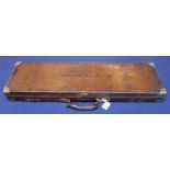 A fine quality leather covered gun case with brass furniture and working lock,