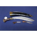 A good quality Kukri with wooden grip and brass mounted leather sheath
