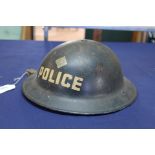 A WWII tin helmet (dated 1939) with original paint and Police insignia