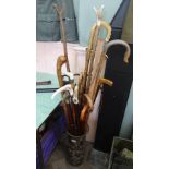 A large collection of various walking sticks (some bespoke) and two shooting sticks,