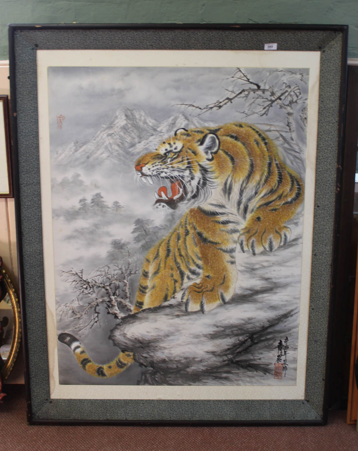 A large Japanese oil on canvas of a winter mountain scene with snarling tiger, signed,