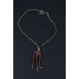A 9ct gold chandelier style pendant set with rubies and diamonds,