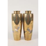 A pair of 19th Century Japanese brass vases with tri metal inlays of wading birds,