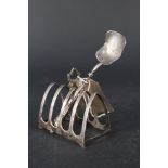 A silver toast rack (as found) and a shovel