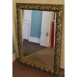 A rectangular gilt framed mirror with leaf decoration