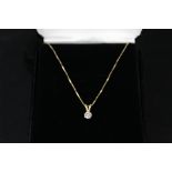 A solitaire white stone set pendant mounted in 14ct gold on 14ct gold chain