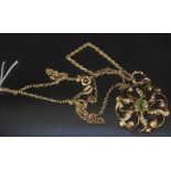 A 9ct gold Art Nouveau style pendant set with seed pearls and green stone on 9ct gold chain