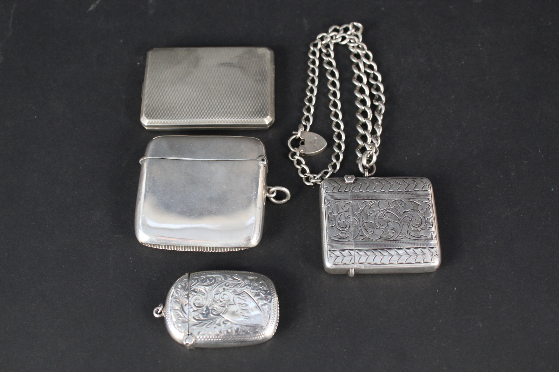 Three silver vesta cases,