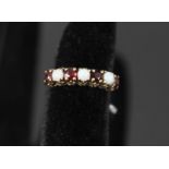 A 9ct gold ring set with opals and garnets,