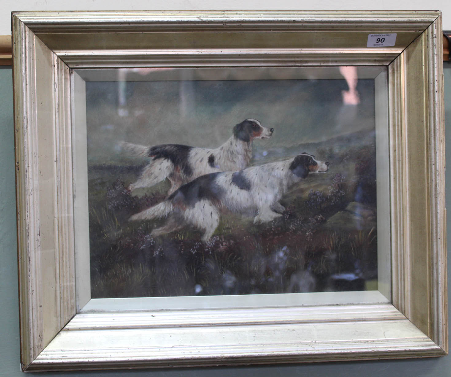 An oil on canvas of two gun dogs on moorland, indistinctly signed,