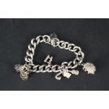 A heavy silver charm bracelet with four charms