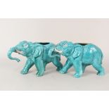 A pair of turquoise glazed elephant vases